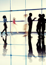 photo of several people waling in an office space